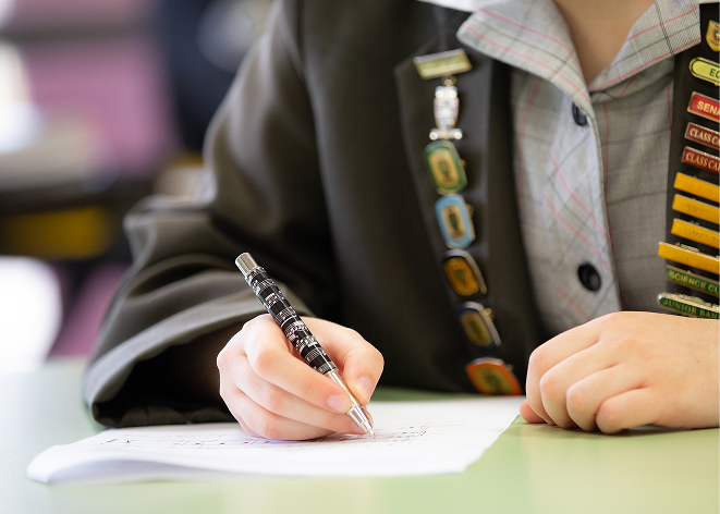 Student Writing On Paper At Mackillop Werribee
